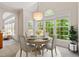 Cozy breakfast nook with a table, four chairs, and natural light from windows at 102 Downing Forest Pl, Cary, NC 27519