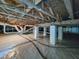 Clean crawl space features moisture barrier, support beams, and insulated pipes at 102 Downing Forest Pl, Cary, NC 27519