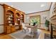Warm home office featuring hardwood floors, custom built-in shelving, and great natural light at 102 Downing Forest Pl, Cary, NC 27519