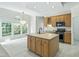 Open kitchen featuring a large island with seating, lots of cabinets and stainless steel appliances at 102 Downing Forest Pl, Cary, NC 27519