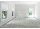 Neutral living room with large windows and carpet ready for you to create your perfect space at 102 Downing Forest Pl, Cary, NC 27519