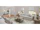 Inviting living room featuring natural light, neutral decor, and view into the dining room at 102 Downing Forest Pl, Cary, NC 27519