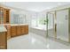 A main bathroom featuring a shower, bathtub, cabinets, and windows at 102 Downing Forest Pl, Cary, NC 27519