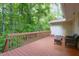 Back deck features a seating area and tree in the background at 103 Westview Dr # Apt K, Carrboro, NC 27510