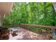 Back deck features a seating area with lush green trees in the background at 103 Westview Dr # Apt K, Carrboro, NC 27510