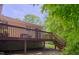View of the wooden back deck with stairs descending into the lush yard at 103 Westview Dr # Apt K, Carrboro, NC 27510