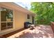 Back deck features a seating area with trees in the background at 103 Westview Dr # Apt K, Carrboro, NC 27510