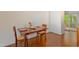 Inviting dining area featuring a wooden table set for two, adjacent to an open kitchen space at 103 Westview Dr # Apt K, Carrboro, NC 27510