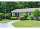 View of the house, highlighting the well-kept lawn, landscaping, and charming architectural details at 103 Westview Dr # Apt K, Carrboro, NC 27510