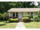 Charming home showcasing a well-manicured lawn, mature trees, and a welcoming front porch at 103 Westview Dr # Apt K, Carrboro, NC 27510