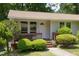 Charming front porch with steps, wooden railings, and well-manicured bushes at 103 Westview Dr # Apt K, Carrboro, NC 27510