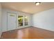 Bright living room featuring hardwood floors, a large window and entry door, and neutral walls at 103 Westview Dr # Apt K, Carrboro, NC 27510