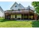 Backyard with large deck and green grass in a residential neighborhood at 105 Bardsey Ct, Cary, NC 27513