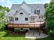 Backyard with large wooden deck and a patio in a residential area at 105 Bardsey Ct, Cary, NC 27513