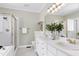 Bathroom featuring double vanity, shower with glass door, white cabinets and countertop at 105 Bardsey Ct, Cary, NC 27513