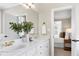 Bathroom featuring double vanity, granite countertop, brass faucets, white cabinets at 105 Bardsey Ct, Cary, NC 27513