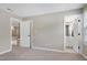 Bedroom featuring neutral carpet and walls and view of bathroom and hallway through doors at 105 Bardsey Ct, Cary, NC 27513