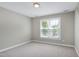 Bedroom featuring neutral carpet and walls, a window with blinds, and simple ceiling light at 105 Bardsey Ct, Cary, NC 27513