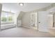 A carpeted bedroom leads to a bathroom, enhancing the home's functionality at 105 Bardsey Ct, Cary, NC 27513