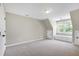 Bright bedroom with carpet, built-in bench seating, and a sunlit window at 105 Bardsey Ct, Cary, NC 27513