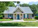 Exterior of the community clubhouse with blue door, blue shutters, and landscaping at 105 Bardsey Ct, Cary, NC 27513
