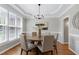 Elegant dining room featuring hardwood floors, tray ceiling, and modern chandelier at 105 Bardsey Ct, Cary, NC 27513