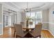Bright dining room features hardwood floors, modern chandelier, and a large window at 105 Bardsey Ct, Cary, NC 27513