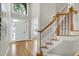Inviting foyer featuring hardwood floors, a staircase, and ample natural light at 105 Bardsey Ct, Cary, NC 27513