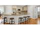Kitchen island with granite countertops, seating, and stainless steel appliances at 105 Bardsey Ct, Cary, NC 27513