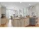 Open-concept kitchen with island, dining area, and stainless steel dishwasher at 105 Bardsey Ct, Cary, NC 27513