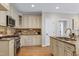 Well-lit kitchen with wooden cabinets, granite countertops, and modern appliances at 105 Bardsey Ct, Cary, NC 27513