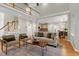Bright, open-concept living room with hardwood floors and access to the kitchen at 105 Bardsey Ct, Cary, NC 27513