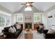 Inviting living room features vaulted ceilings, fireplace with stone surround, custom cabinetry, and hardwood floors at 105 Bardsey Ct, Cary, NC 27513
