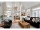 Inviting living room with open layout, hardwood floors, comfortable seating, and views of the upper level and dining area at 105 Bardsey Ct, Cary, NC 27513