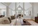 Spacious living room features vaulted ceilings, fireplace, multiple windows, hardwood floors, and stylish furnishings at 105 Bardsey Ct, Cary, NC 27513