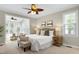 Cozy main bedroom features a spacious layout, plush carpet, side tables, and access to the bright sun room at 105 Bardsey Ct, Cary, NC 27513