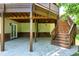 Covered patio features direct backyard access and staircase to the deck at 105 Bardsey Ct, Cary, NC 27513