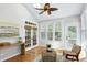 Bright sun room features skylights, multiple windows, wood floors, and cozy seating area at 105 Bardsey Ct, Cary, NC 27513