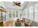 Bright sun room features skylights, multiple windows, wood floors, and cozy seating area at 105 Bardsey Ct, Cary, NC 27513