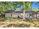 Back exterior view of the home with a tree and patio at 106 Blackfoot Dr, Louisburg, NC 27549