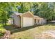 This cozy home features an attached one-car garage and a manicured yard, nestled among mature trees at 106 Blackfoot Dr, Louisburg, NC 27549