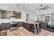A sleek kitchen showcasing a large island with marble countertop, contrasting with dark cabinets and modern appliances at 106 Blackfoot Dr, Louisburg, NC 27549