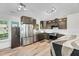 Modern kitchen with dark cabinets, stainless steel appliances, and a black and white countertop island at 106 Blackfoot Dr, Louisburg, NC 27549