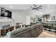 Spacious living room features vaulted ceilings, a ceiling fan, and flows into the eat-in kitchen at 106 Blackfoot Dr, Louisburg, NC 27549