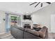 Cozy living room features a fireplace, TV, and a large window that provides natural light at 106 Blackfoot Dr, Louisburg, NC 27549