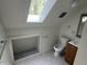 Small bathroom with wood vanity, toilet, and open space for storage at 108 Horseman Dr, Louisburg, NC 27549