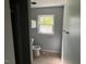 Clean and simple bathroom design with modern toilet, window, and neutral color scheme at 108 Horseman Dr, Louisburg, NC 27549