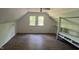 Bonus room offering shelving for storage and natural light from two windows at 108 Horseman Dr, Louisburg, NC 27549