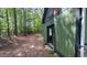 Exterior view of the home showing wooded surroundings and access to the backyard at 108 Horseman Dr, Louisburg, NC 27549