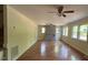 Spacious living room featuring hardwood floors, a modern ceiling fan, and a fireplace at 108 Horseman Dr, Louisburg, NC 27549